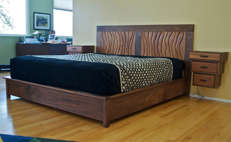Kings size walnut and cherry bed  with sculpted headboard and floating night stands.  